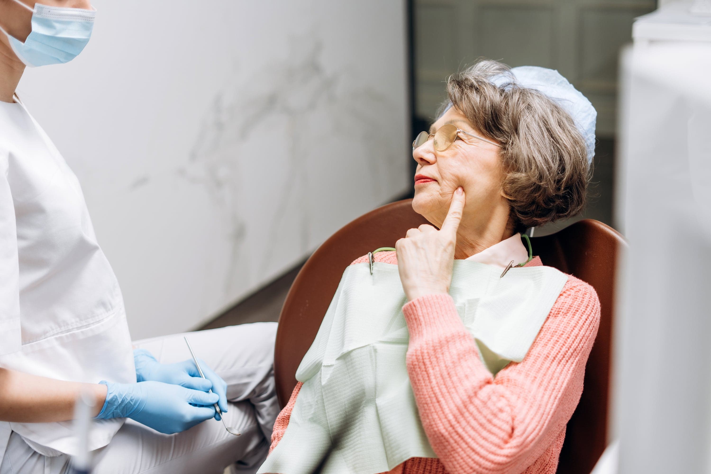 Dentist assessing patient for denture consultation at Joyner Family Dental