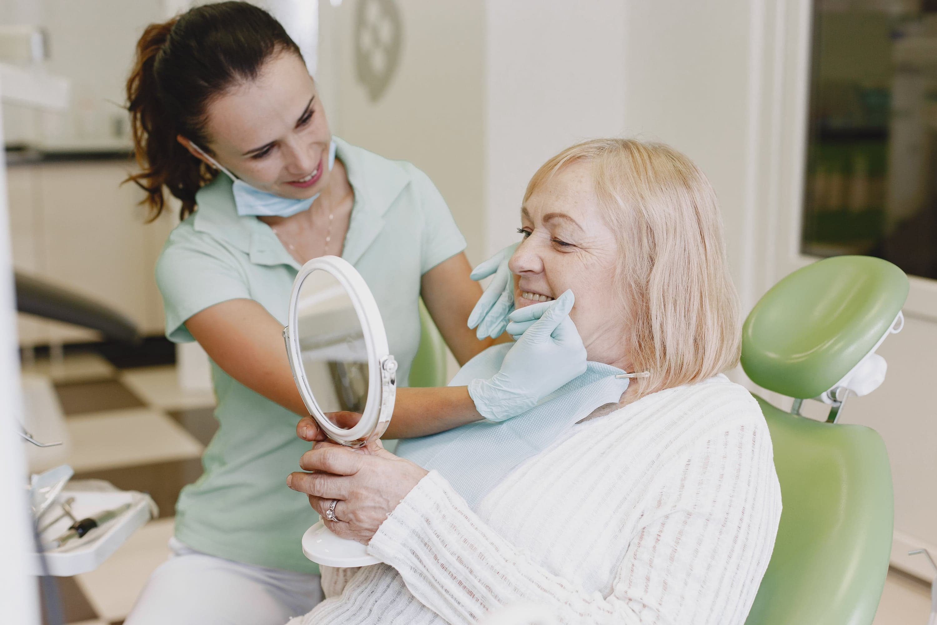 Patient trying wax denture model for fit and appearance check