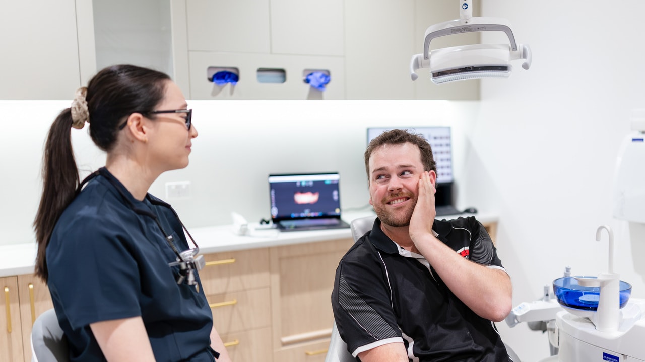 Dentist and patient reviewing clear aligner options on a tablet