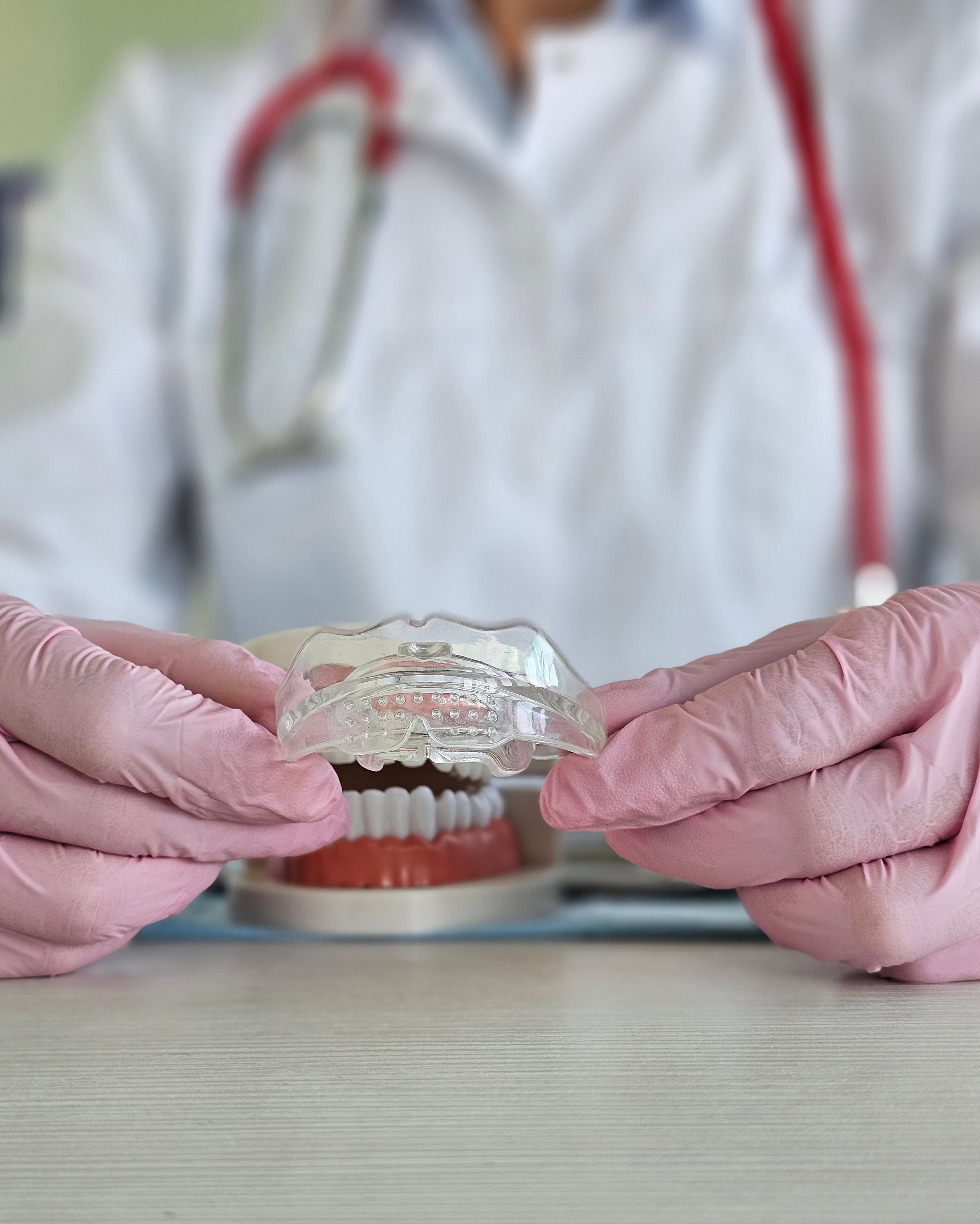 Parent and child holding a sports mouthguard case at training