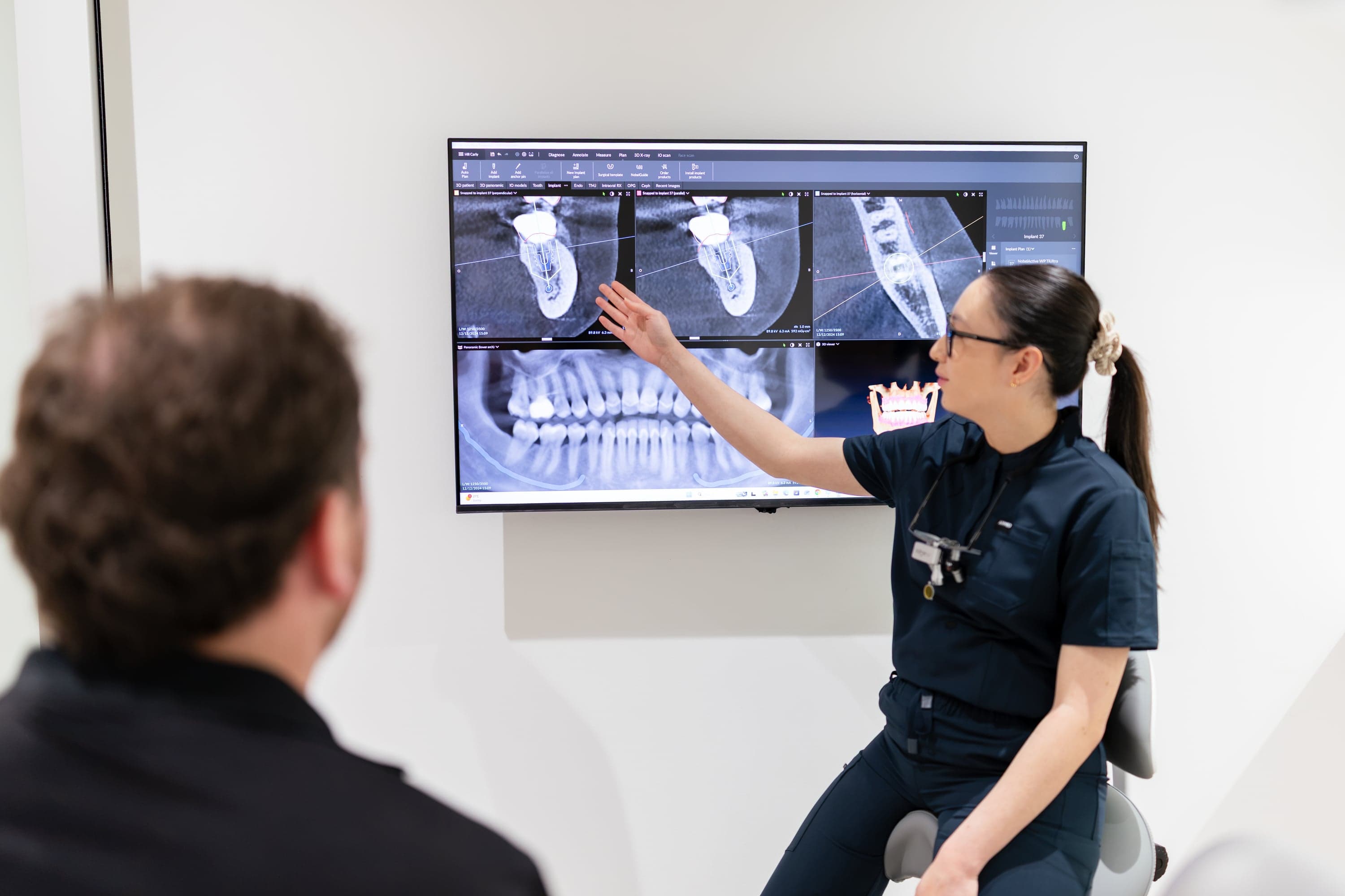 Dentist discussing treatment options and costs with a patient