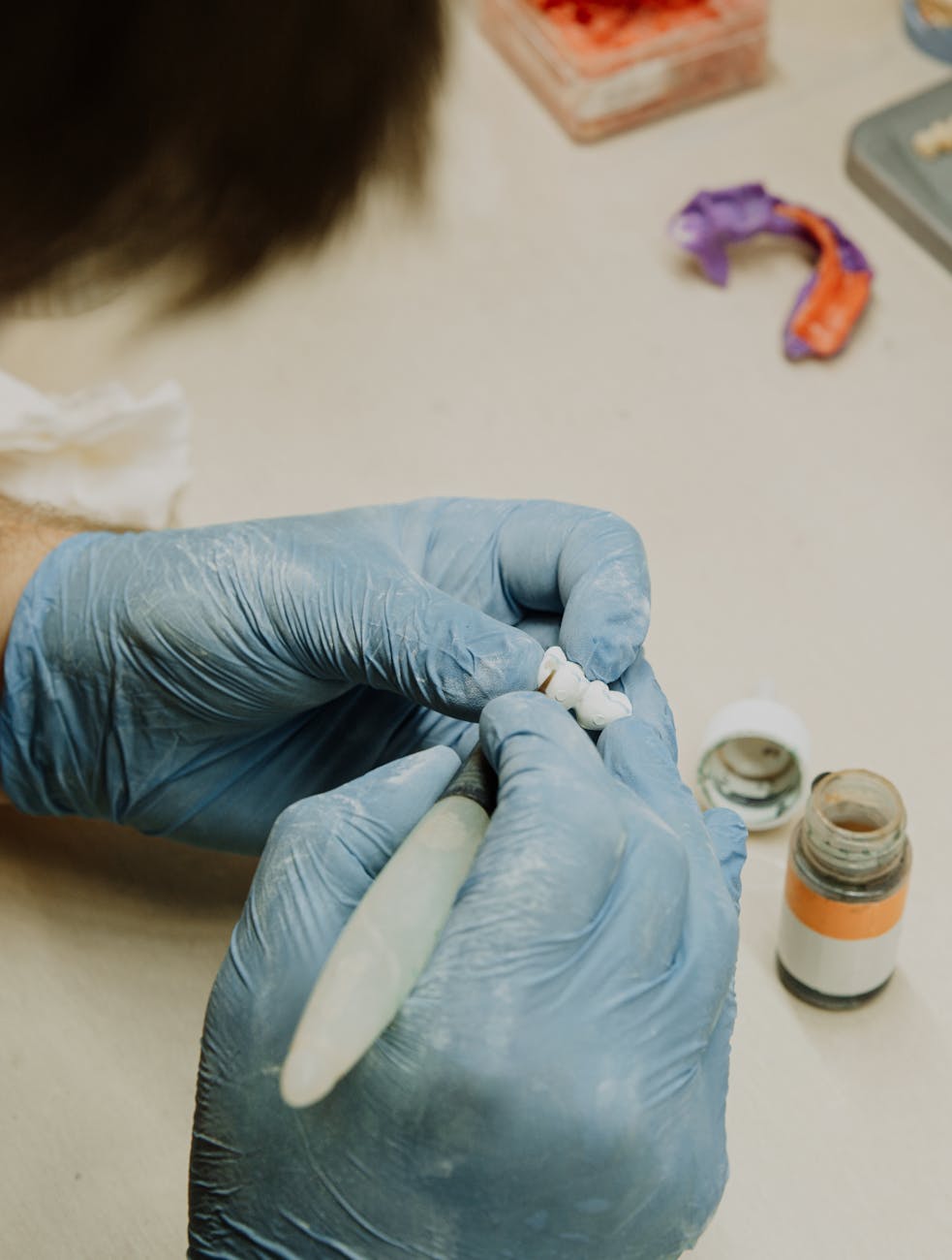 Dental technician carefully crafting custom dentures in the laboratory