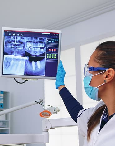 Dentist using dental technology during a patient consultation