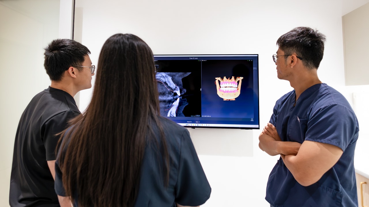 Dentist explaining dental X-ray to patient at Joyner Family Dental