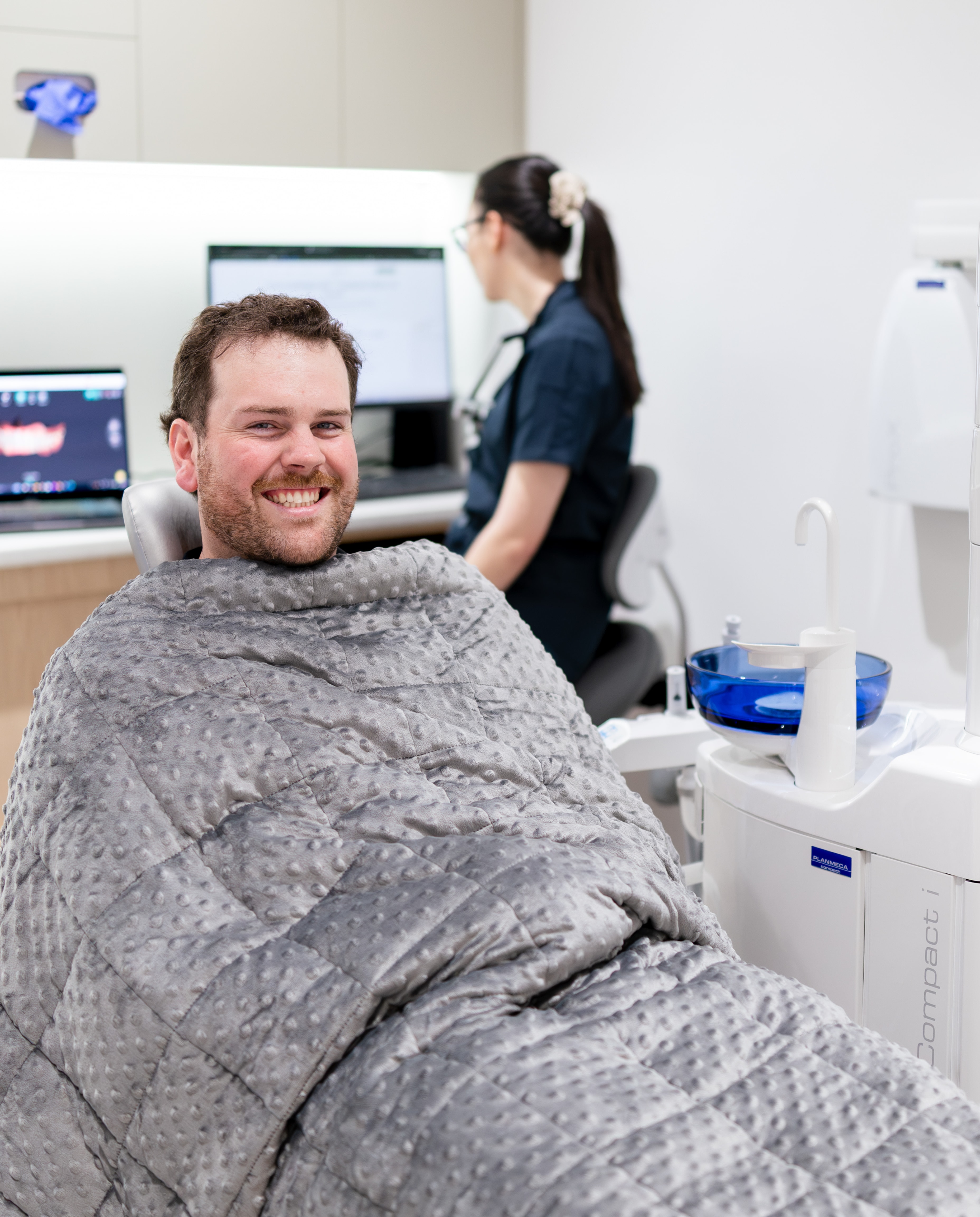A patient in a relaxed consultation with their dentist at Joyner Family Dental before a tooth extraction